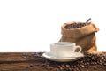 Cup of coffee and coffee beans on old wooden table isolated on white background Royalty Free Stock Photo