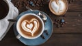 cup of coffee and beans A rustic wood table with a coffee cup that has a heart shaped cream. The cup is white with a blue plate Royalty Free Stock Photo