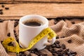 Cup of coffee with beans and tape measure still life Royalty Free Stock Photo