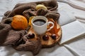 Cup of coffee in bed and autumn decorated background