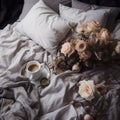 Cup of coffee on the bed with a bouquet of flowers. Royalty Free Stock Photo