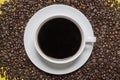 Cup of coffee on a bed of coffee beans Royalty Free Stock Photo