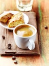 Cup of Coffee with a Biscotti. Symbolic image. Rustic wooden background. Royalty Free Stock Photo