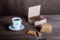 Cup of coffee, biscuits and a box of cigarettes on old wooden ta Royalty Free Stock Photo