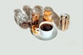 Cup coffee biscuits cinnamon stick chocolate cookies white background glass jars shadow Royalty Free Stock Photo