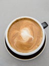 Cup of coffee in a black mug, from above