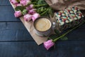 A cup of coffee is on the book. Bouquet of roses. A gift on Valentine`s Day. A special place for text. Royalty Free Stock Photo