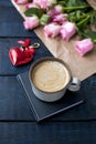 A cup of coffee is on the book. Bouquet of roses. Red heart. A gift on Valentine`s Day. A special place for text. Royalty Free Stock Photo