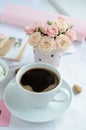 Cup of coffee and a bouquet of roses Royalty Free Stock Photo