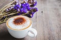 A cup of coffee with bouquet of violet dried flowers on wooden f Royalty Free Stock Photo