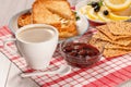 Cup of coffee, bowl with strawberry jam and toasted slices of bread with cheese on white plate Royalty Free Stock Photo