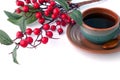 Cup of coffee and branch of hawthorn, breakfast background