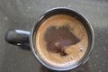 A cup of coffee with brown liquid