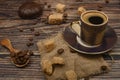 Cup of coffee, brown sugar, coffee beans, marshmallows in chocolate on wooden background Royalty Free Stock Photo