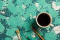 Cup of coffee, brush and pencils on a blue-blue background