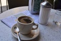 Cup of coffee at Cafe Du Monde in New Orleans French Quarter and map of French Quarter