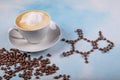 A cup of coffee with caffeine molecule created by coffee beans Royalty Free Stock Photo