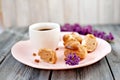 Cup of coffee, cakes and branch of a lilac Royalty Free Stock Photo