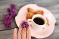 Cup of coffee, cakes and hand with a lilac branch Royalty Free Stock Photo