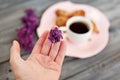 Cup of coffee, cakes and hand with a lilac branch Royalty Free Stock Photo