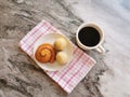 A cup of coffee and cakes on kitchen table. Royalty Free Stock Photo