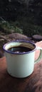 a cup of coffee at the campground against the river