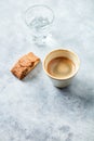 Cup of coffee with cantuccini Italian biscuit on bright stone background.