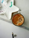 A cup of coffee capuchino, ceramic plate and graphite pencil on the table Royalty Free Stock Photo