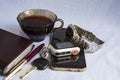 A Cup of coffee, a cell phone, a notebook, a ballpoint pen, a car key with a keychain Royalty Free Stock Photo