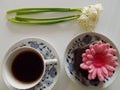 Cup of coffee, chocholate muffin with pink flower, snowdrops, from above