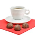 A cup of coffee and chocolate candies isolated on white background. Royalty Free Stock Photo