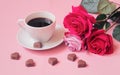 Cup of coffee, chocolate candies and pink roses. Selective focus Royalty Free Stock Photo