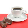 Cup of coffee and chocolate candy isolated on white background Royalty Free Stock Photo