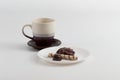 Cup of coffee and chocolate candy, marsh-mallow and wafer roll on plate Royalty Free Stock Photo