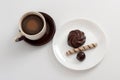 Cup of coffee and chocolate candy, marsh-mallow and wafer roll on plate Royalty Free Stock Photo