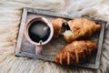 Cup of coffee with chocolate croissants