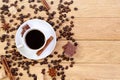 Cup of coffee, chocolate, sugar, spices and coffee beans on a wooden background Royalty Free Stock Photo