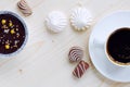 Cup of coffee, chocolates, meringue, a cottage cheese dessert of handwork on a wooden background Royalty Free Stock Photo