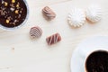 Cup of coffee, chocolates, meringue, a cottage cheese dessert of handwork on a wooden background Royalty Free Stock Photo