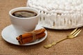 Cup of coffee, cinnamon, fork and biscuit cake decorated with wh Royalty Free Stock Photo