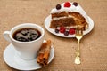 Cup of coffee, cinnamon, fork and slice of biscuit cake with raspberries Royalty Free Stock Photo