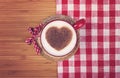 Cup of coffee with cinnamon heart on wooden table . St. Valentin