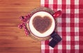 Cup of coffee with cinnamon heart on wooden table . St. Valentin