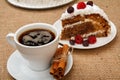 Cup of coffee, cinnamon and slice of biscuit cake decorated with whipped cream and raspberries Royalty Free Stock Photo