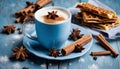 A cup of coffee with cinnamon and star anise on a blue plate