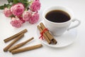 A cup of coffee with cinnamon on a white background.Roses morning Royalty Free Stock Photo