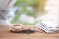 Cup of coffee with coffee beam`s and newspapers, near the window Royalty Free Stock Photo