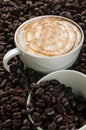 Cup of coffee on coffee beans background,selected focus.