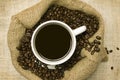 Cup Of Coffee With Coffee Beans In Bag Royalty Free Stock Photo