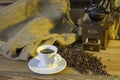 Cup of coffee, coffee-beans, coffee grinder, coffee sack Royalty Free Stock Photo